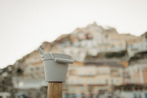 Grey Silicone Beach Toy set on a wooden post in the Amalfi Coast of Italy